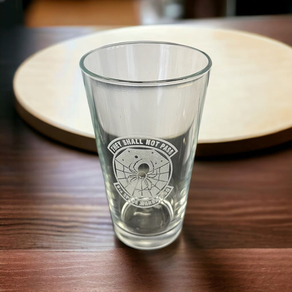 engraved pint glass on table