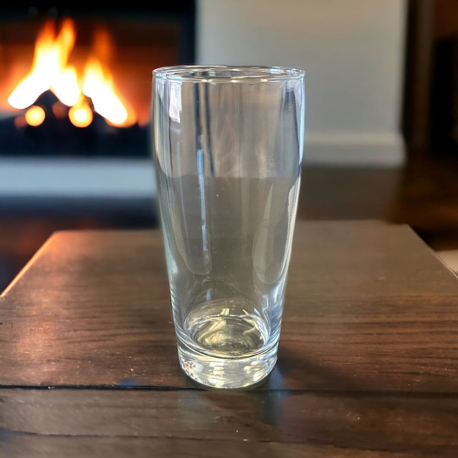 Willi Becher Beer glass on table in front of fireplace